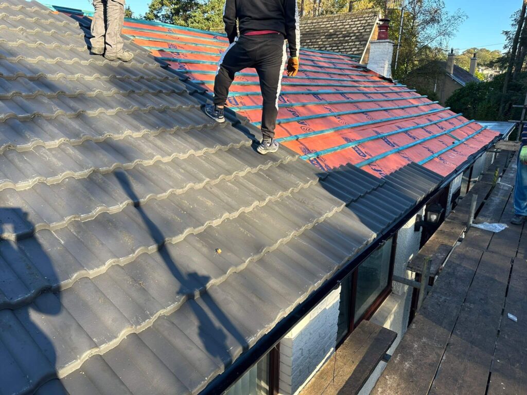 new roof cost harrogate workers tiling a roof | Kennedy Roofing