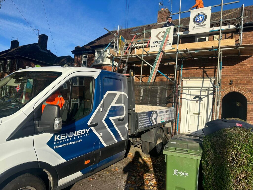 Yorkshire Roofers A Kennedy Roofers van outside a house having a new roof