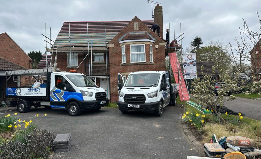 two vans outside a house | Kennedy Roofing